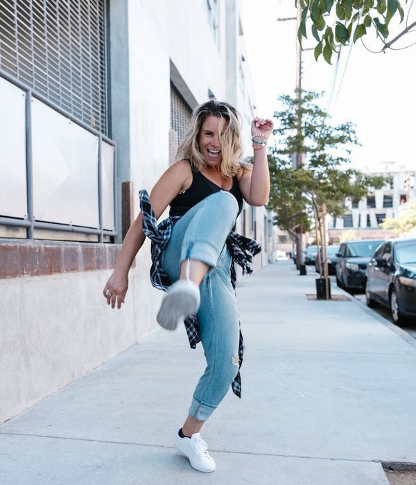 Woman feeling vibrant and energetic in a bright, open space.